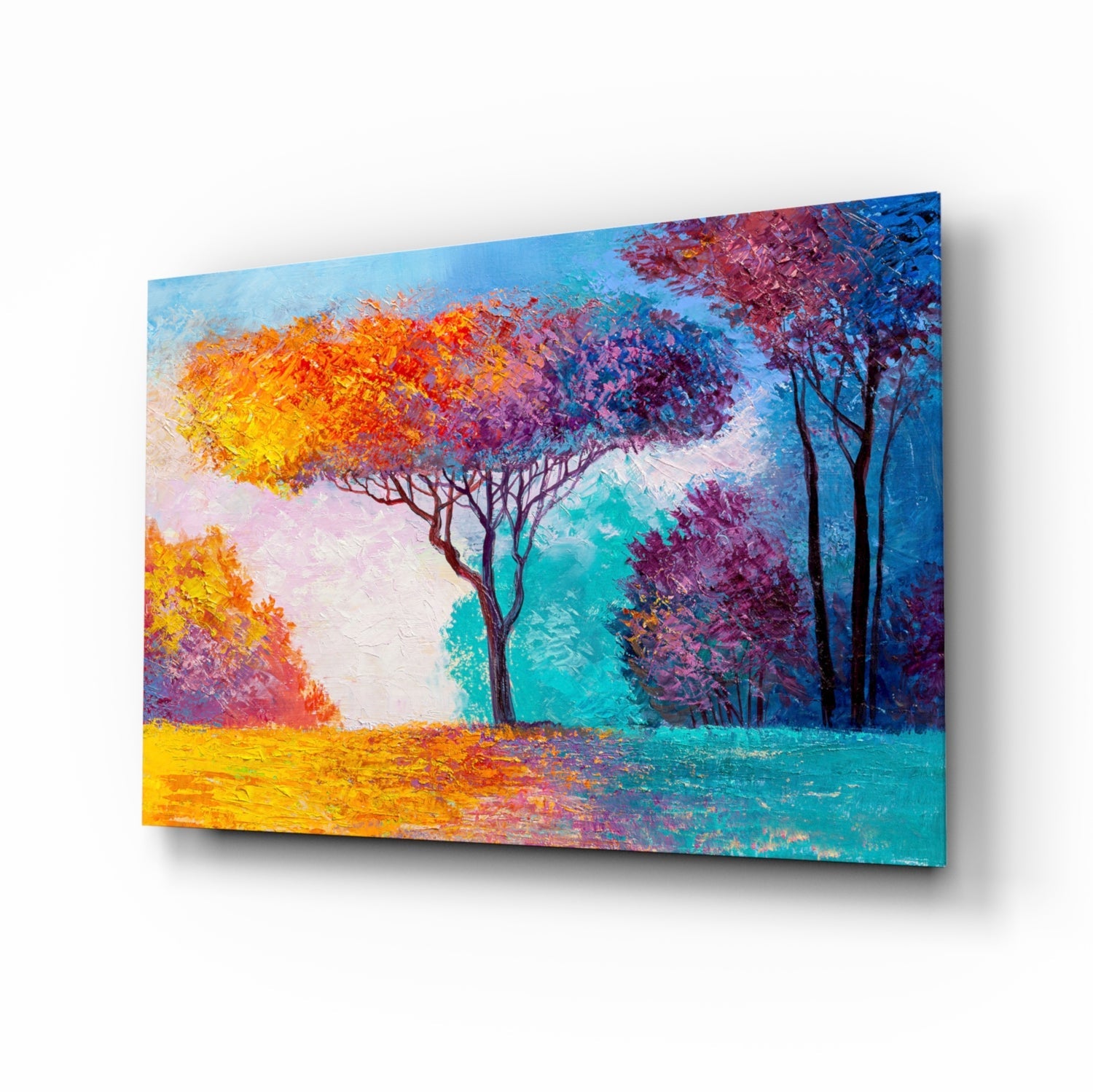 Angled perspective of colorful glass wall art featuring autumn trees in vibrant yellows, oranges, purples, and teals with brushstroke textures.
