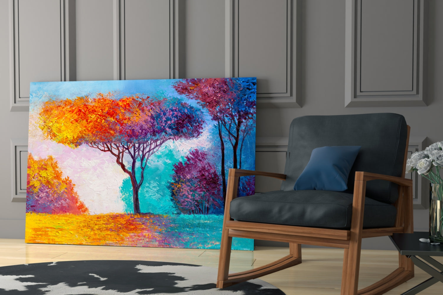 Colorful glass wall art depicting vibrant trees with yellow, orange, and purple foliage against a turquoise and blue sky, displayed in a modern interior beside a wooden rocking chair.