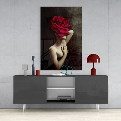 Modern living room display featuring gray media console with red lamp and decorative items beneath surreal artwork of woman with large crimson rose head.