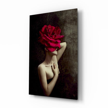 Woman with bare shoulders and arm raised, head replaced by large crimson rose, against dark textured background on glass panel.