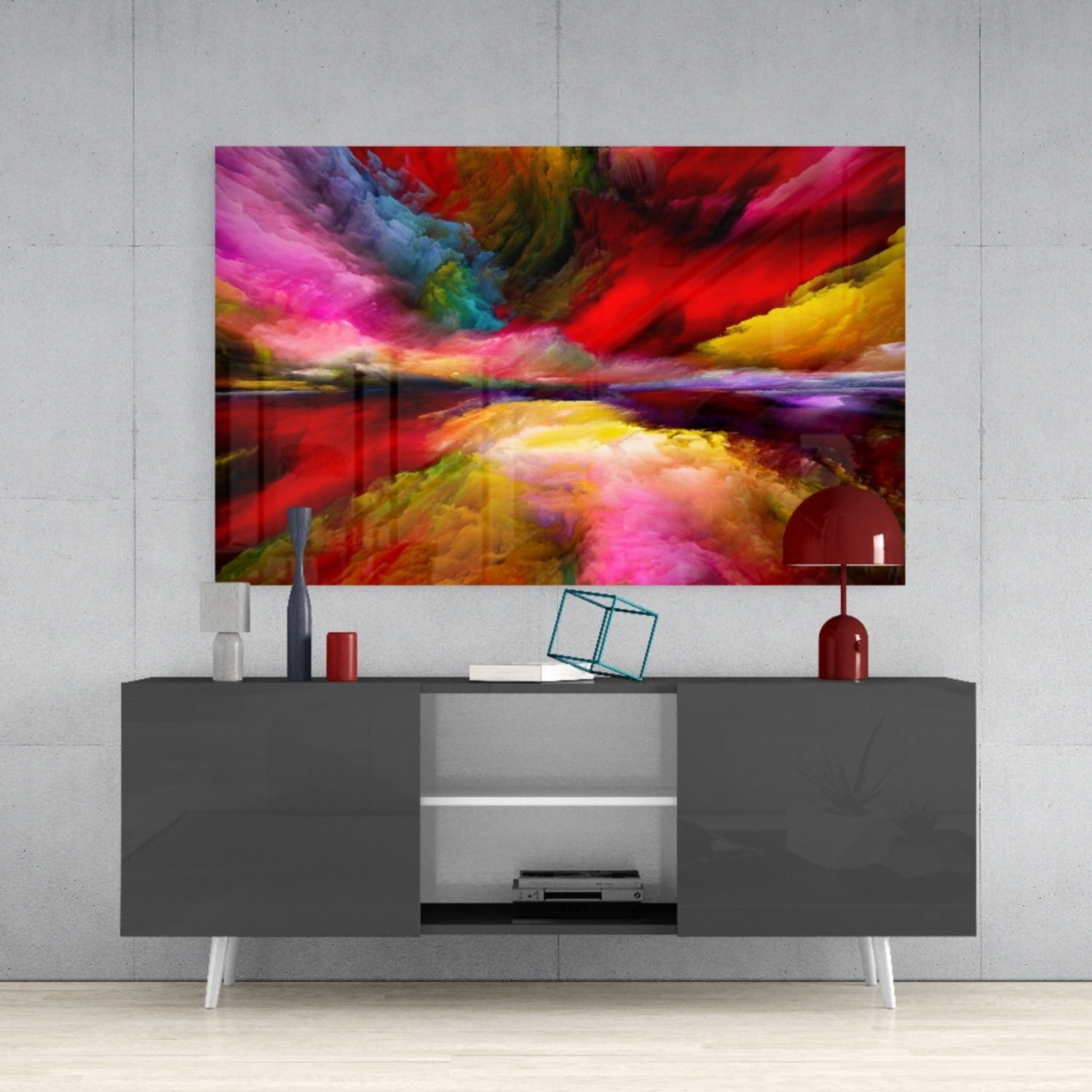 Colorful abstract landscape glass art mounted above a dark gray media console displaying vibrant pink, red, yellow, and blue hues.