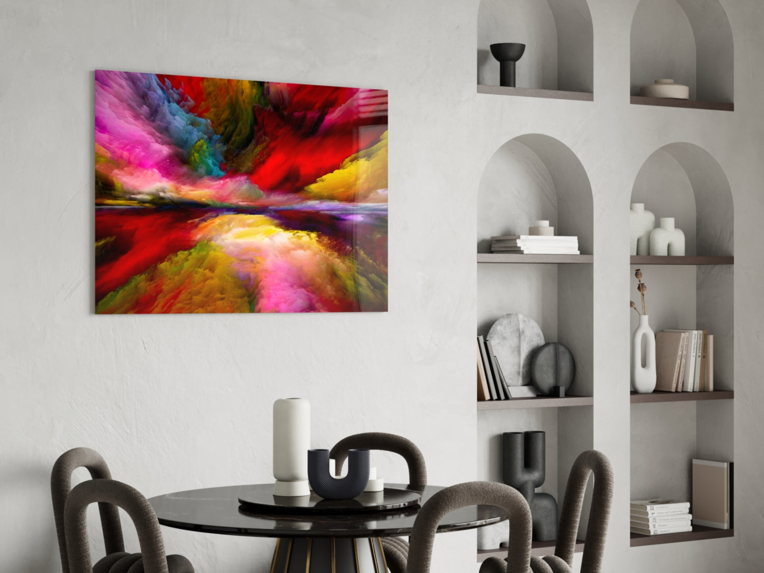 Vibrant abstract glass wall art with pink, red, yellow, and blue swirling colors displayed above a dining table.