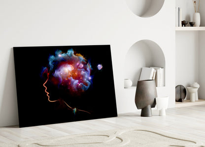 Framed glass art leaning against white wall displays glowing neon profile with colorful cosmic cloud burst in minimalist interior setting.