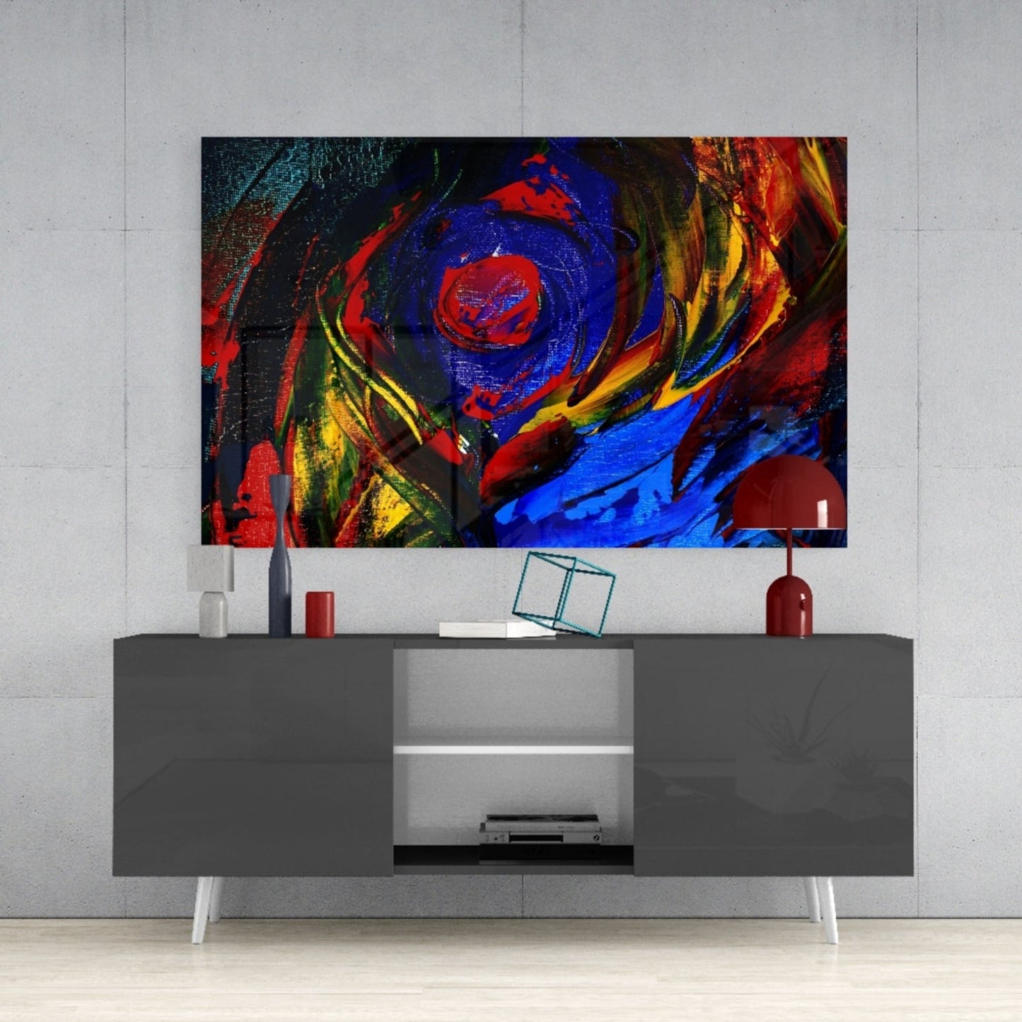 Vibrant abstract oil painting glass wall art featuring red, blue, yellow, and orange swirling patterns displayed above a gray media console.