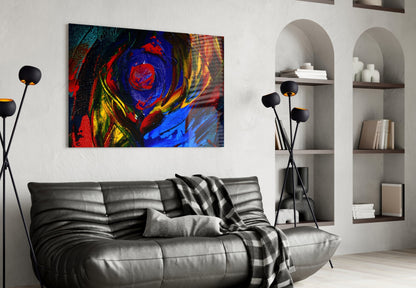 Colorful abstract oil painting glass wall art featuring red, blue, and yellow swirls displayed above a black leather sofa in a modern living room interior.