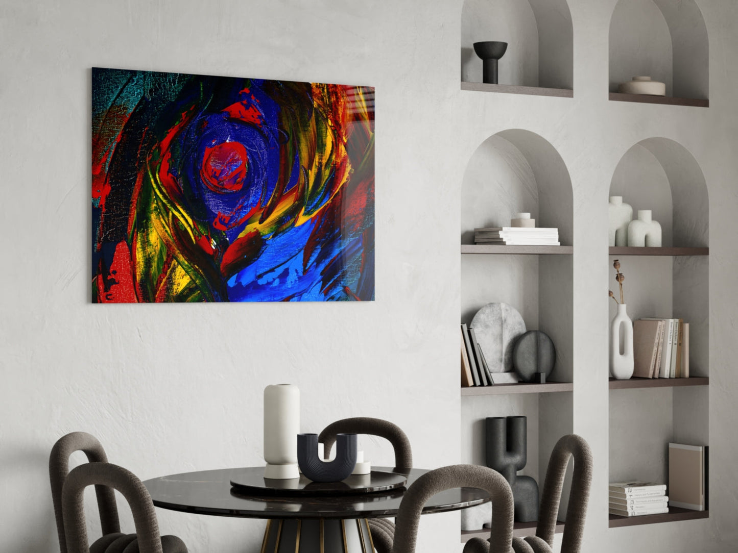 Vibrant abstract oil painting glass art with red, blue, and yellow swirls displayed above a dining table in a modern interior.