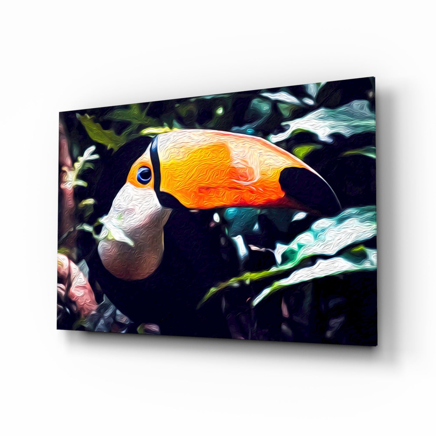 Toco toucan glass wall art displayed at an angle, showing vibrant orange and yellow beak with white and black plumage against a dark foliage background.