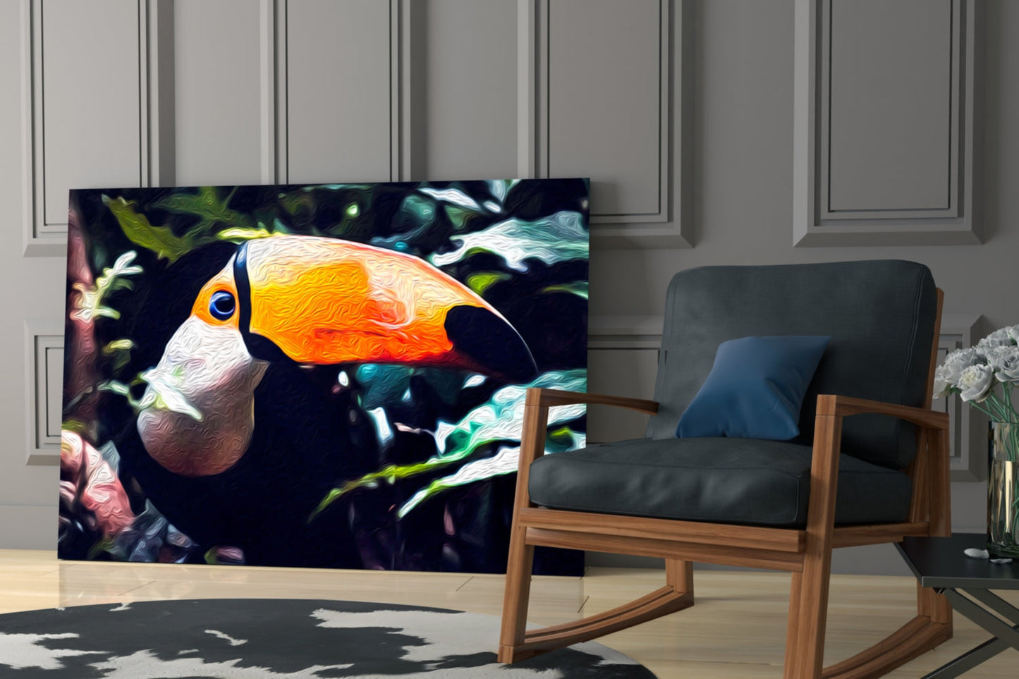 Toco Toucan glass wall art displayed in a modern living room beside a wooden rocking chair, showing vibrant orange, yellow, and white bird against dark foliage background.