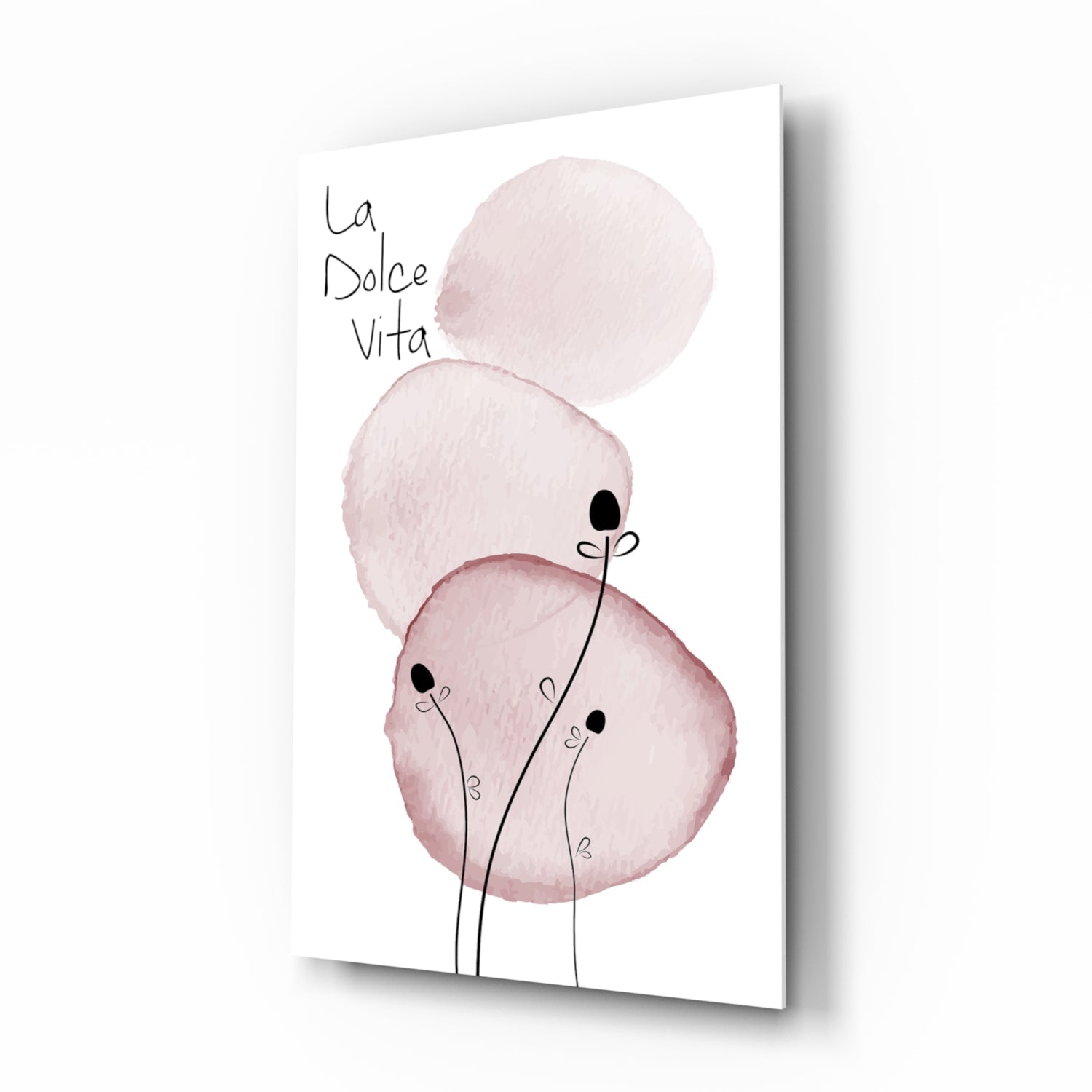 Pink watercolor circles with black stem figures and "la Dolce Vita" text on white glass panel, angled perspective view.