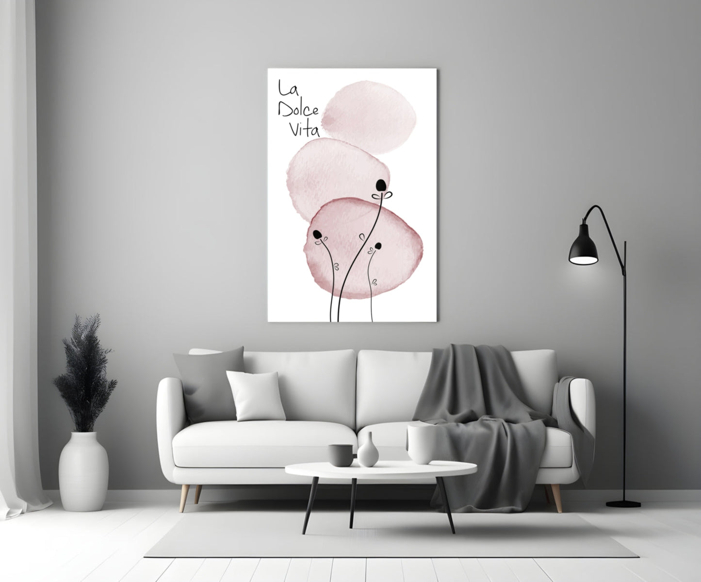 La Dolce Vita glass wall art with pink watercolor circles and stick figures displayed above a white sofa in a modern living room.
