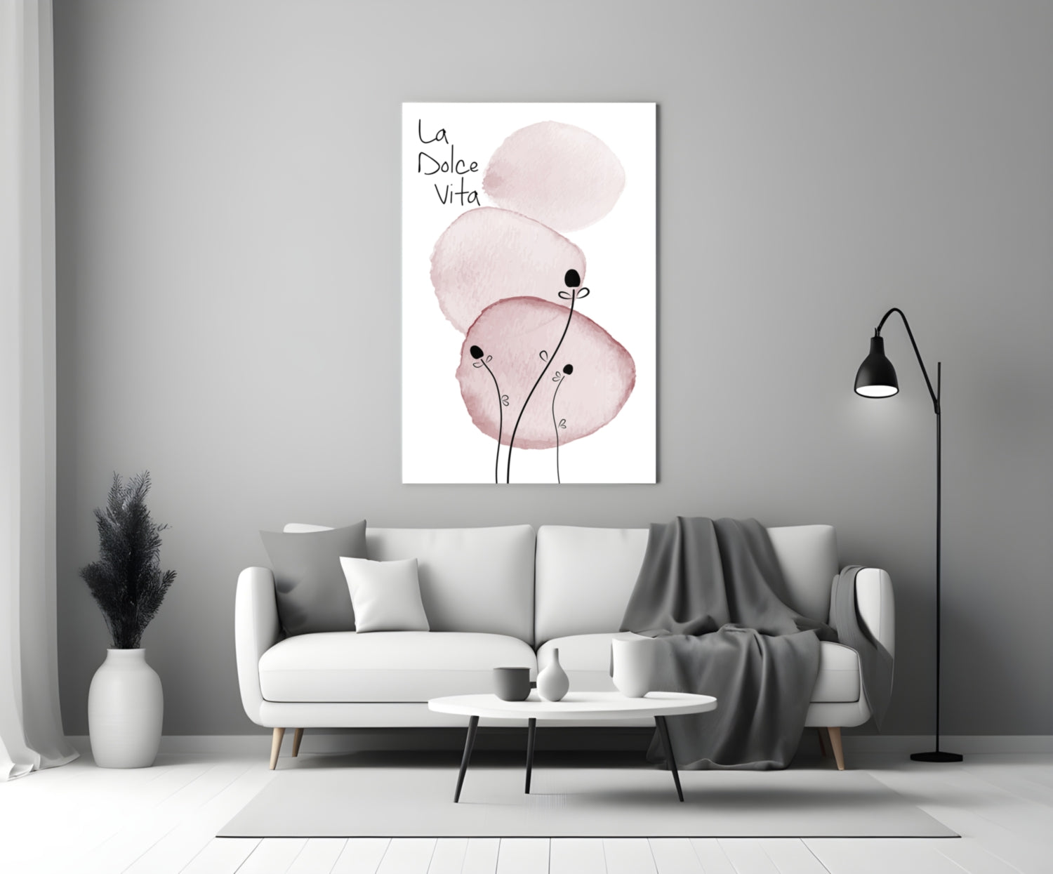 La Dolce Vita glass wall art with pink watercolor circles and stick figures displayed above a white sofa in a modern living room.