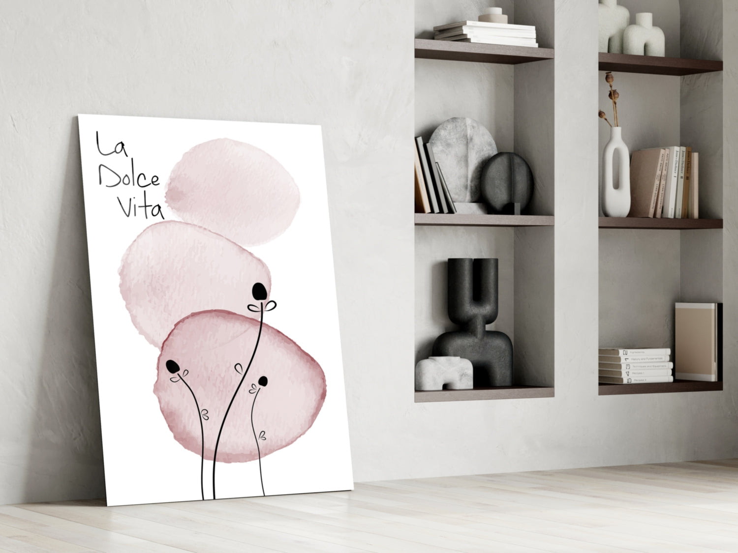 La Dolce Vita glass art leaning against white wall showing pink watercolor circles with stick figures and Italian text, styled room setting with shelving.