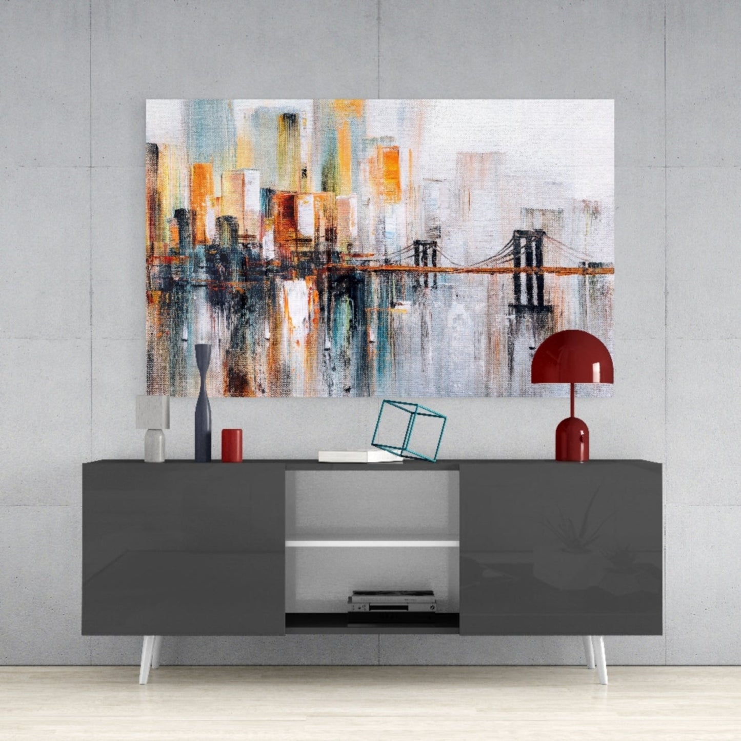 Modern living room display showing Ghost Town glass wall art hung above a dark gray media console with red decorative lamp and accessories.