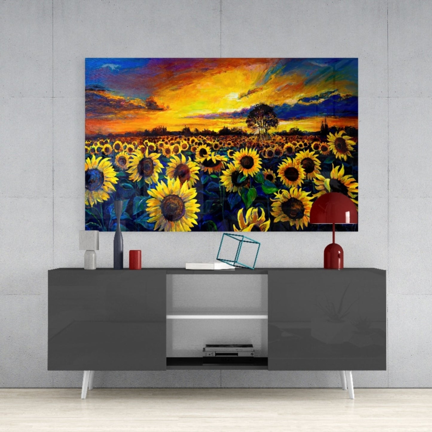 Colorful sunflower field glass art panel mounted above gray TV console in modern living room setting.