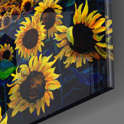 Angled side view of glass wall art displaying vibrant yellow and orange sunflowers against a deep blue background.