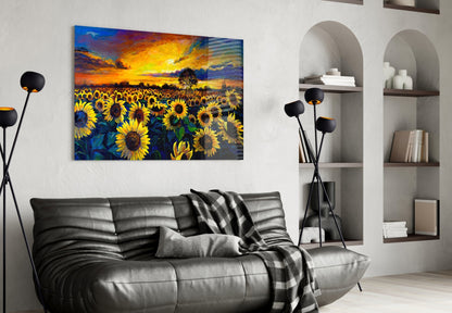 Vibrant sunflower field sunset glass wall art displayed above black leather sofa in modern living room.