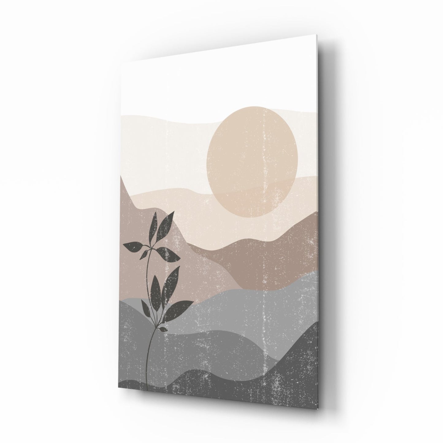 Small Leaves Glass Wall Art displayed at an angle, showing layered landscape with beige moon, dark plant silhouette, and textured gray mountains against white sky.