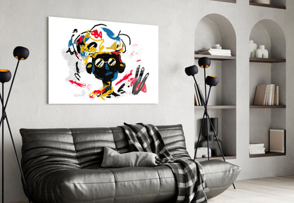 Colorful abstract portrait with yellow, red, and blue brushstrokes hangs above black leather sofa in modern living room.