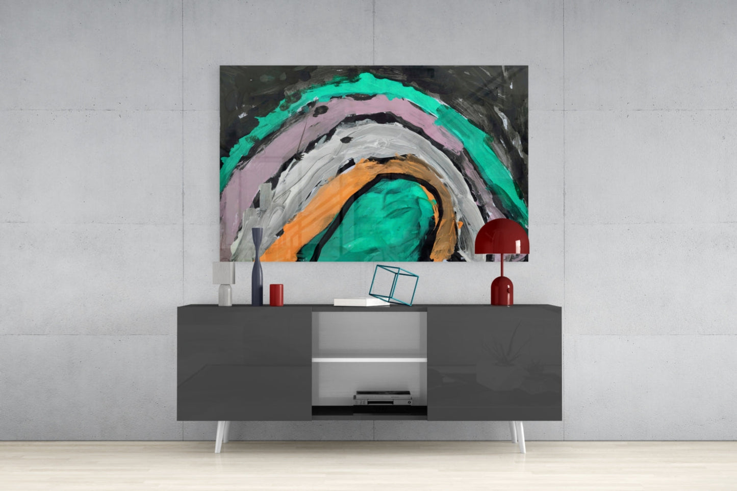 Modern living room with gray media console displaying abstract glass wall art featuring concentric circles in turquoise, pink, orange, and white.