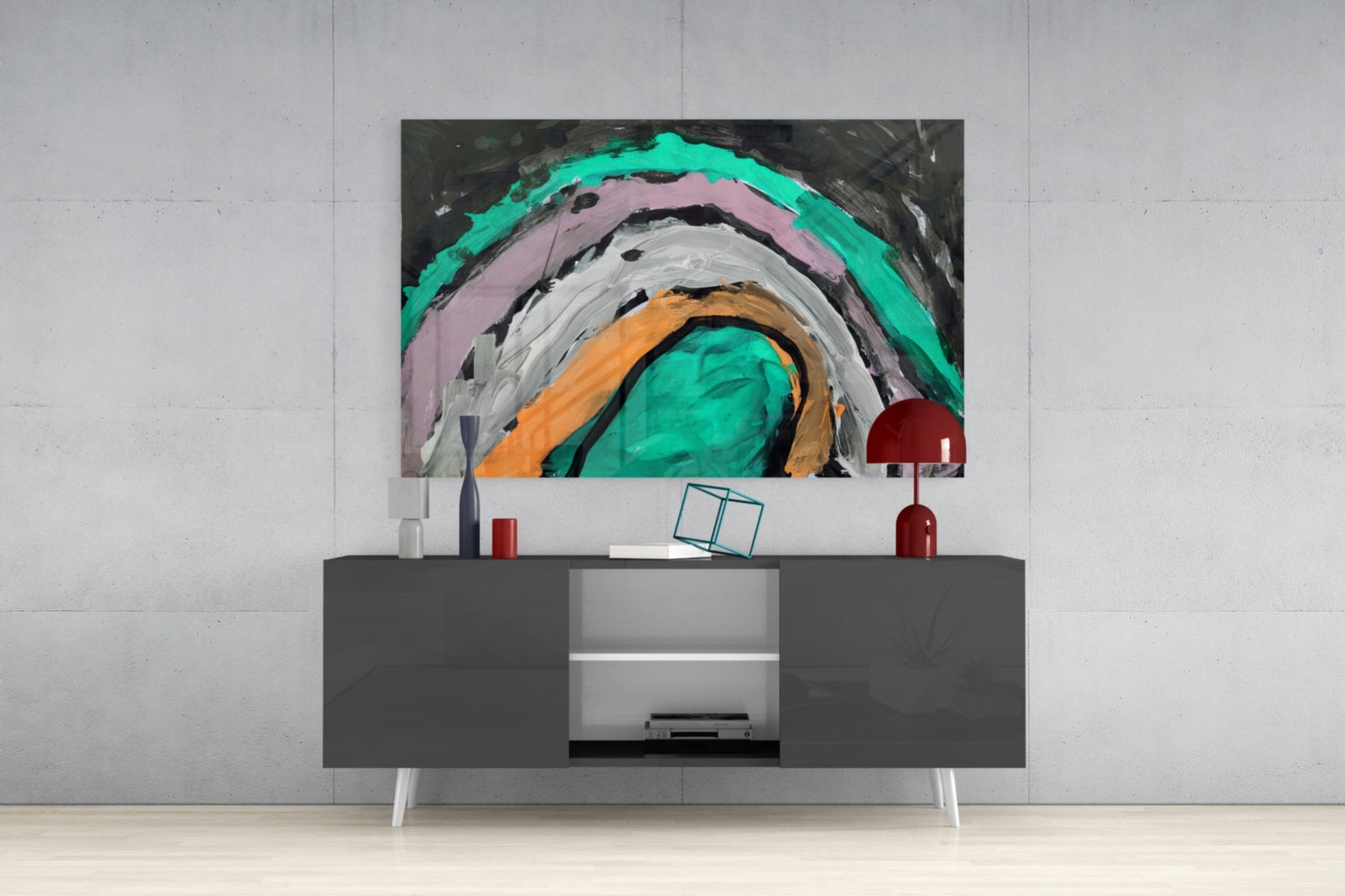 Modern living room with gray media console displaying abstract glass wall art featuring concentric circles in turquoise, pink, orange, and white.