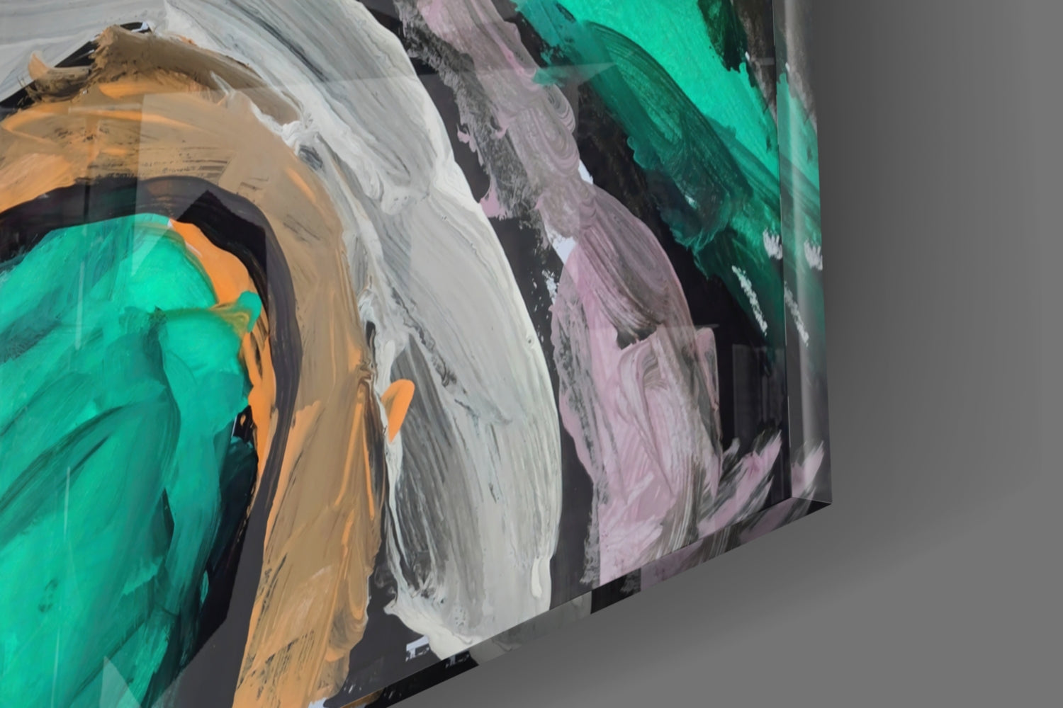 Angled close-up of translucent glass wall art panels displaying layered brushstrokes in turquoise, white, pink, orange, and black pigments.