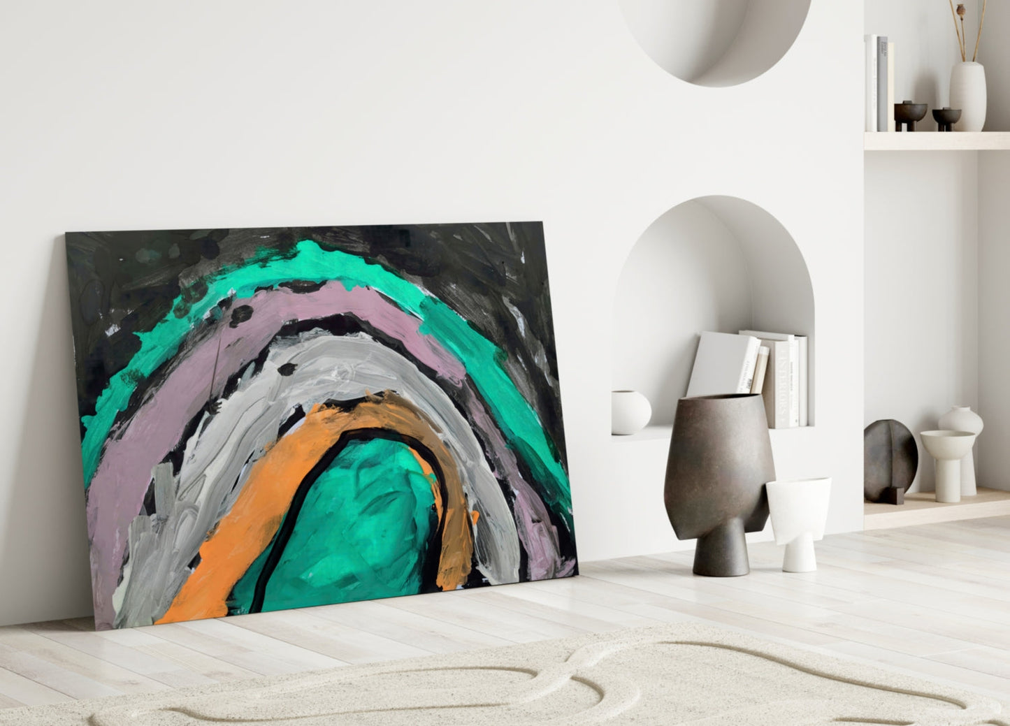 Colorful abstract glass art with concentric circles in turquoise, pink, gray, orange, and black, leaning against white wall in minimalist interior.