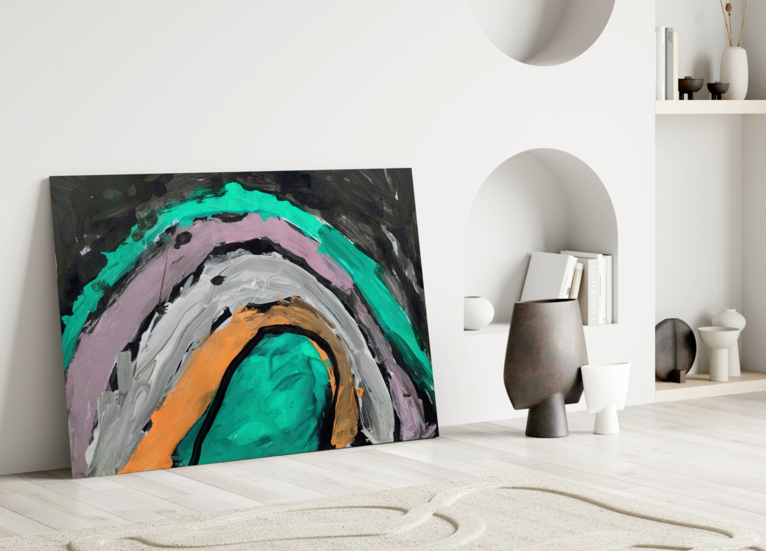 Colorful abstract glass art with concentric circles in turquoise, pink, gray, orange, and black, leaning against white wall in minimalist interior.