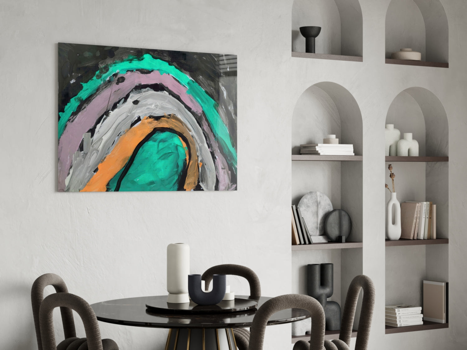 Selmin Glass Wall Art with concentric circles in turquoise, pink, gray, orange, and black hung above a round black dining table with chairs.