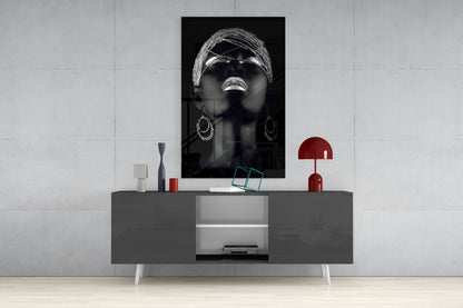 Black and white portrait of woman wearing sunglasses and hoop earrings displayed above modern gray console table with red accents.