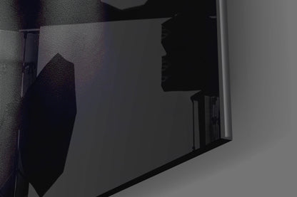 Close-up angled view of silver woman profile glass wall art mounted on textured wall, showing silhouette detail.
