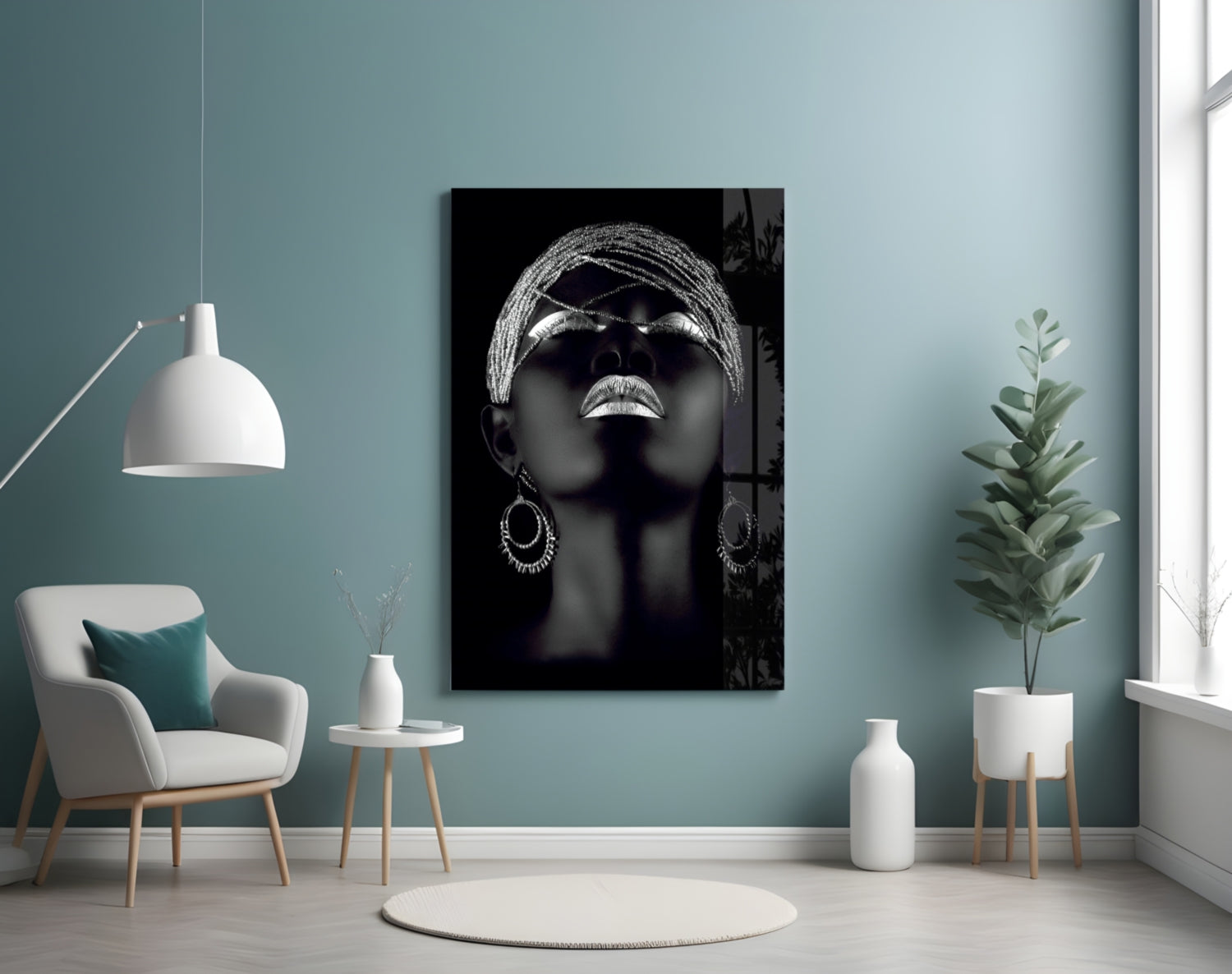 Black and white glass wall art depicting a woman's face with head wrap and sunglasses in modern interior setting.
