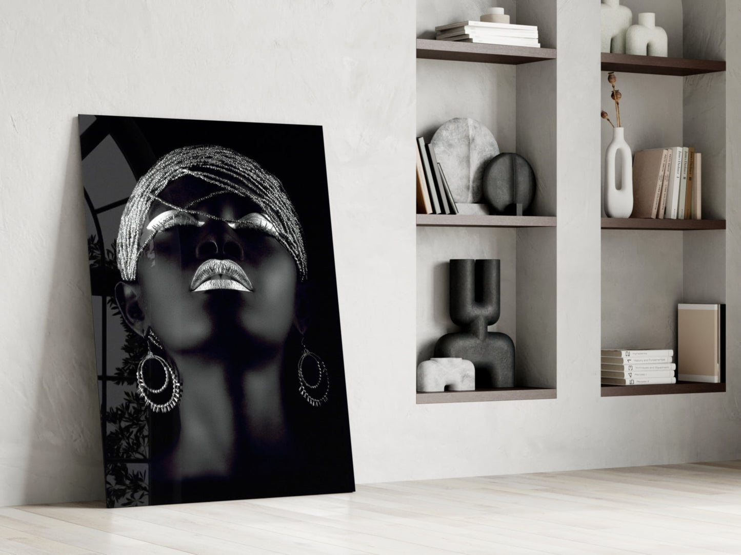 Black and white glass portrait of woman wearing sunglasses and hoop earrings, leaning against white wall with wooden shelves.
