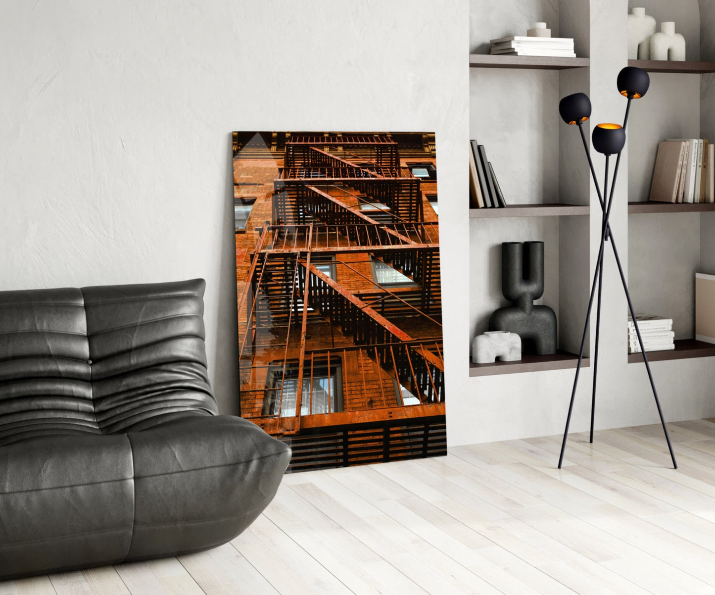 Orange Stairs glass wall art displayed in modern living room with gray leather chair, black floor lamp, and white shelving unit.
