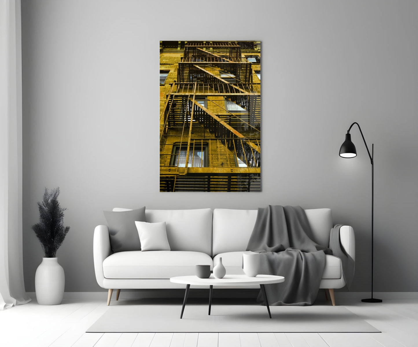 Yellow metal fire escape stairs on brick building facade with multiple windows and dark railings.