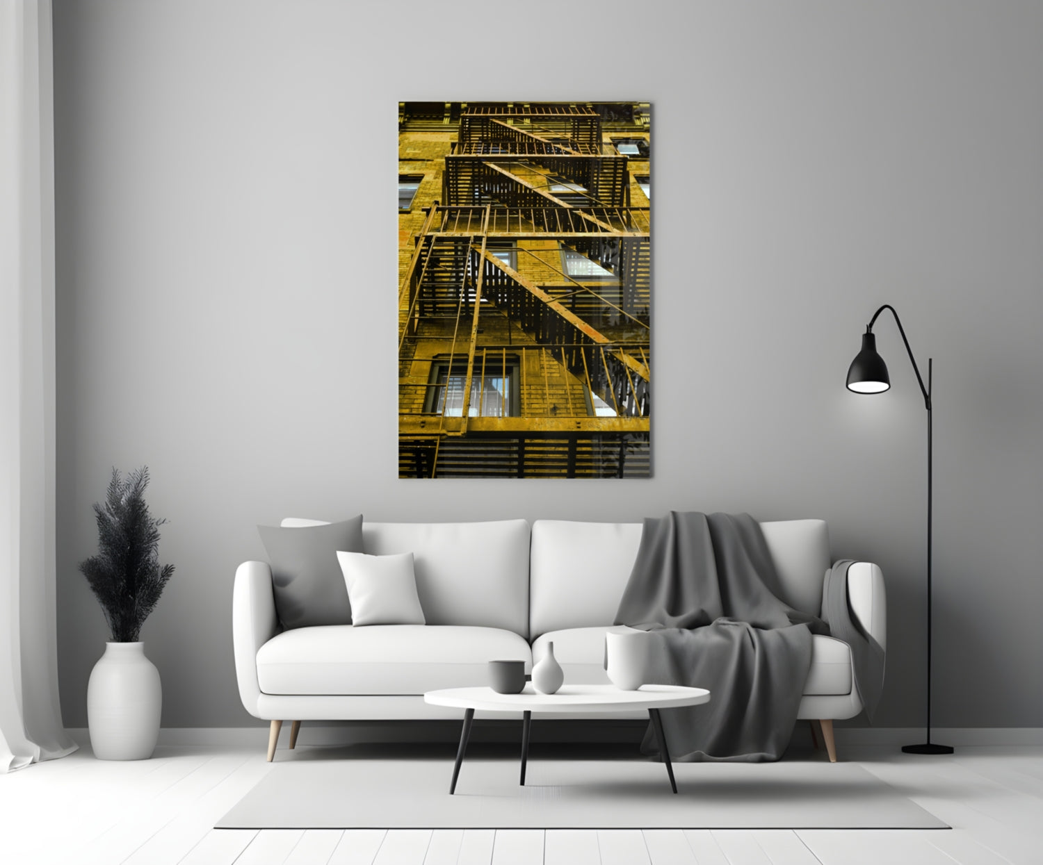Yellow metal fire escape stairs on brick building facade with multiple windows and dark railings.