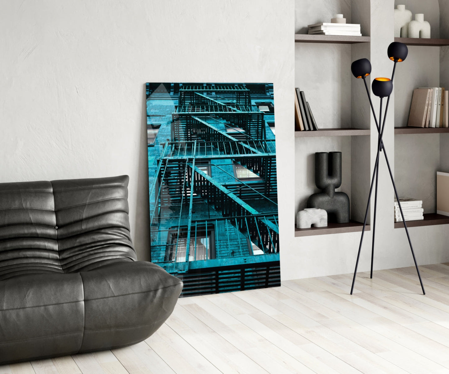 Blue Stairs Glass Wall Art displayed in modern living room beside gray leather chair and black floor lamp with shelving.
