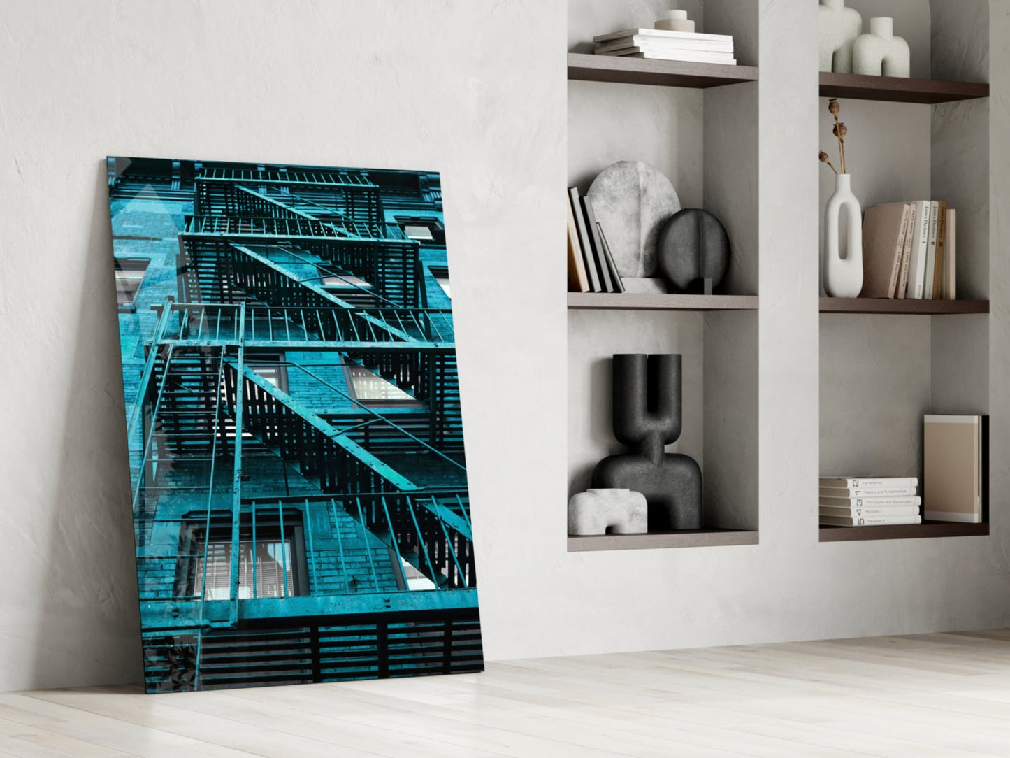 Blue Stairs Glass Wall Art leaning against white wall next to shelving unit displaying decorative objects and books.