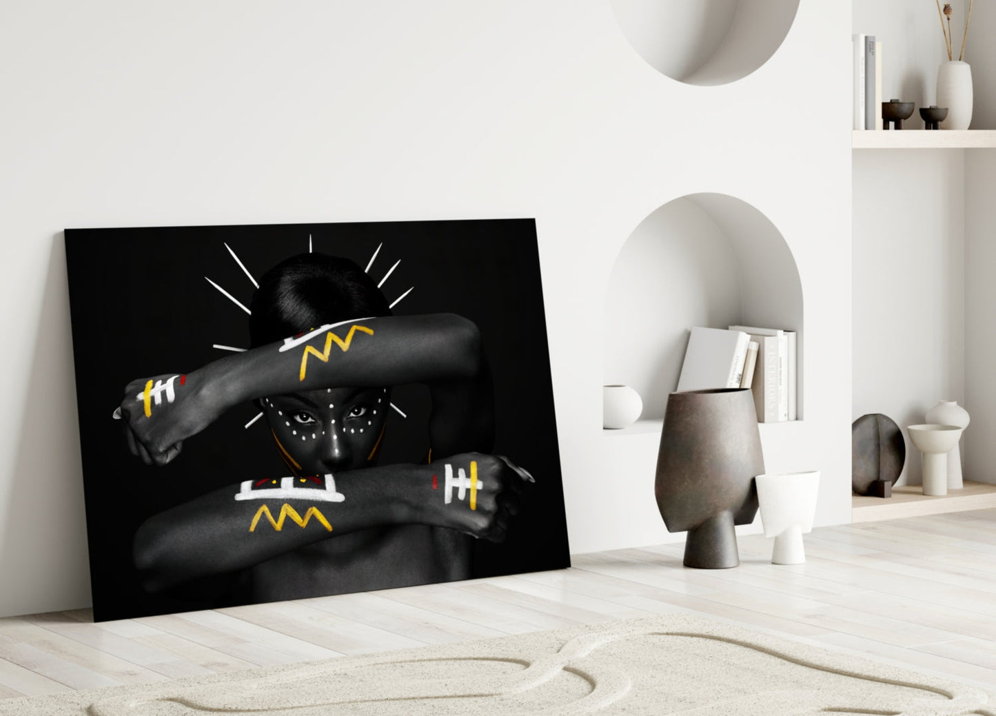 Black glass wall art featuring stylized portrait with yellow and white geometric designs, leaning against white wall in minimalist interior setting.