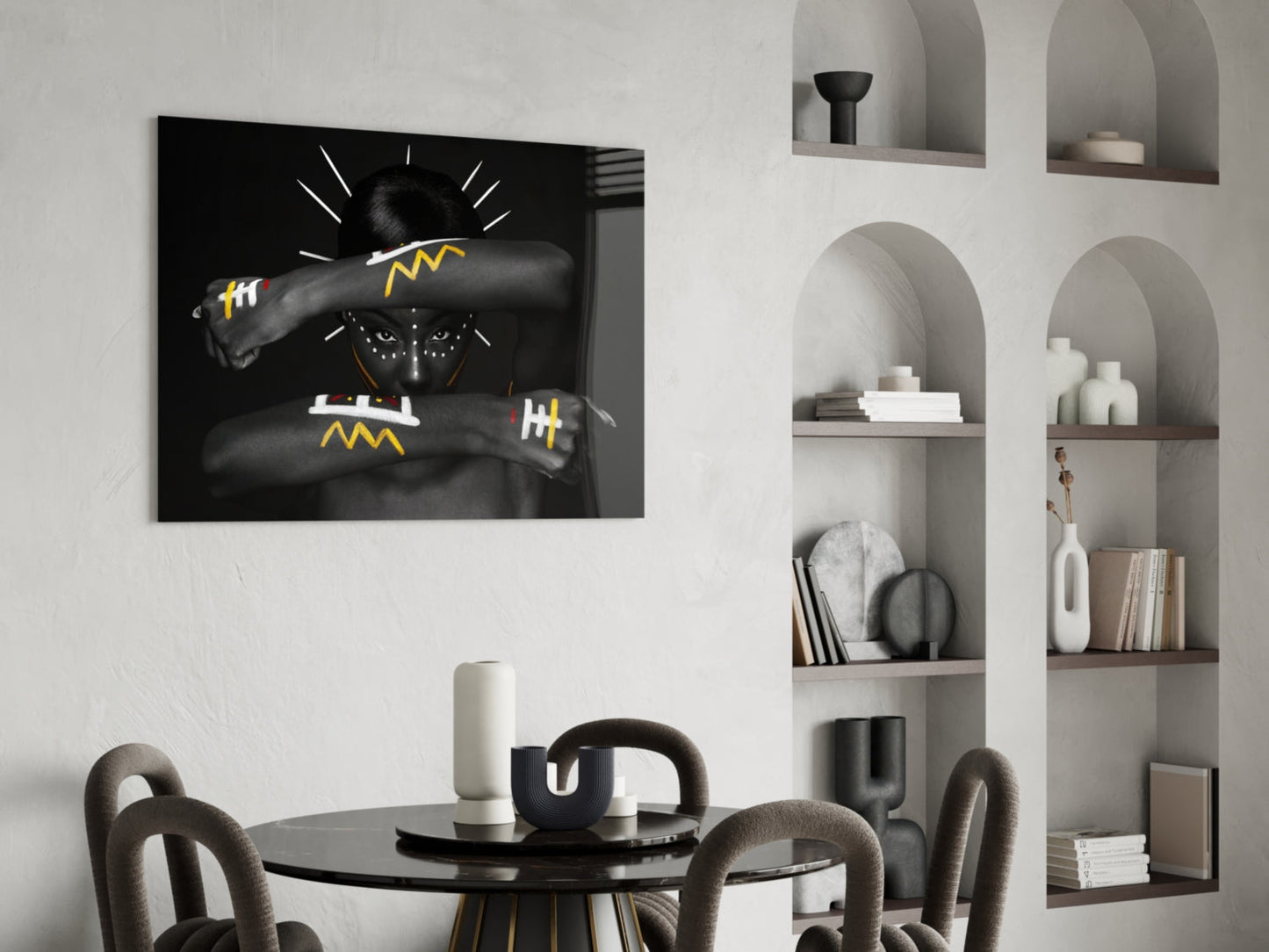 Black glass wall art depicting a figure with lightning bolt designs, displayed above a dining table in a modern interior setting.