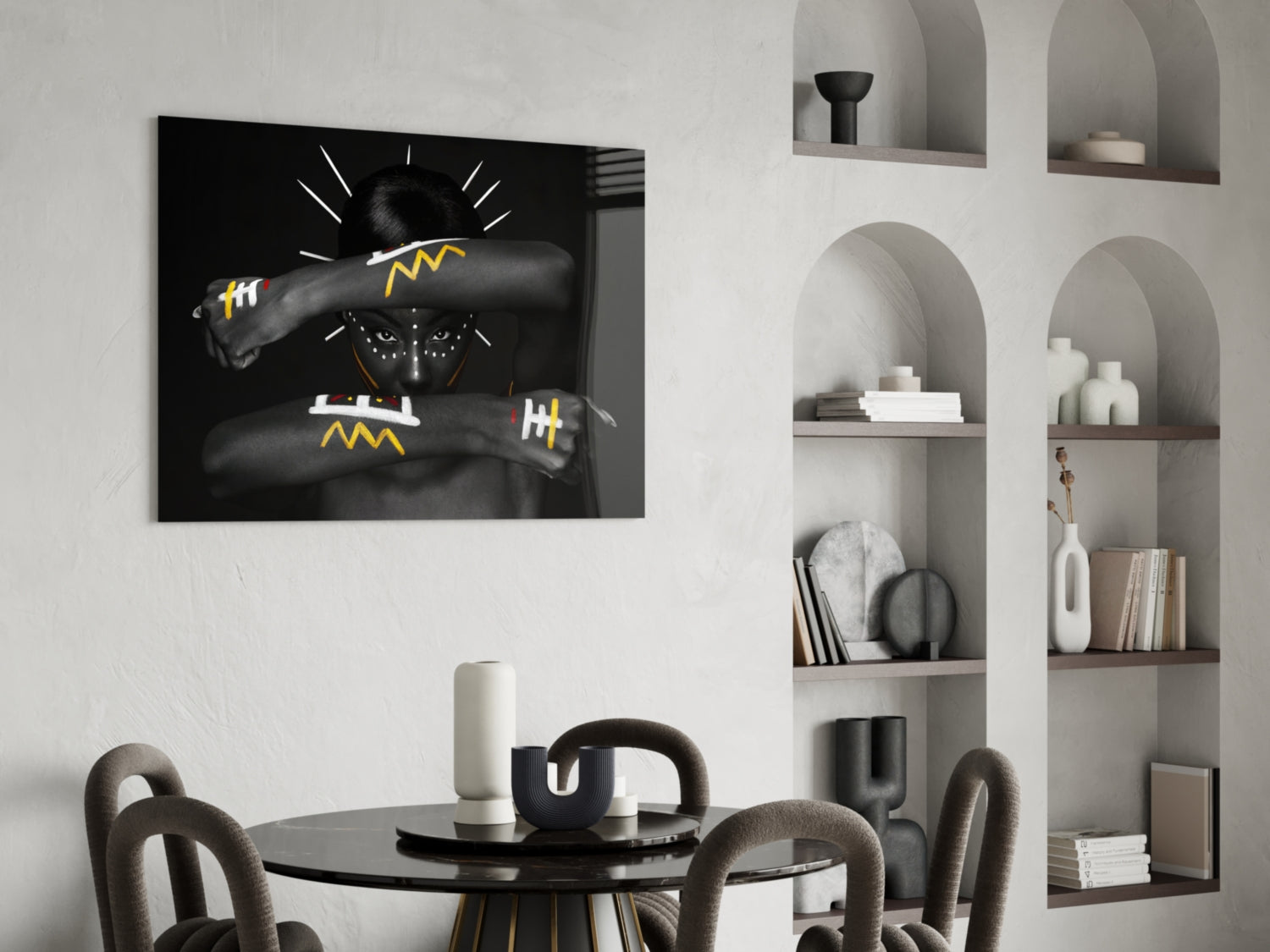 Black glass wall art depicting a figure with lightning bolt designs, displayed above a dining table in a modern interior setting.