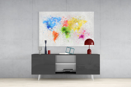 Colorful watercolor world map glass art displayed above dark gray console table with red lamp and decorative accessories.