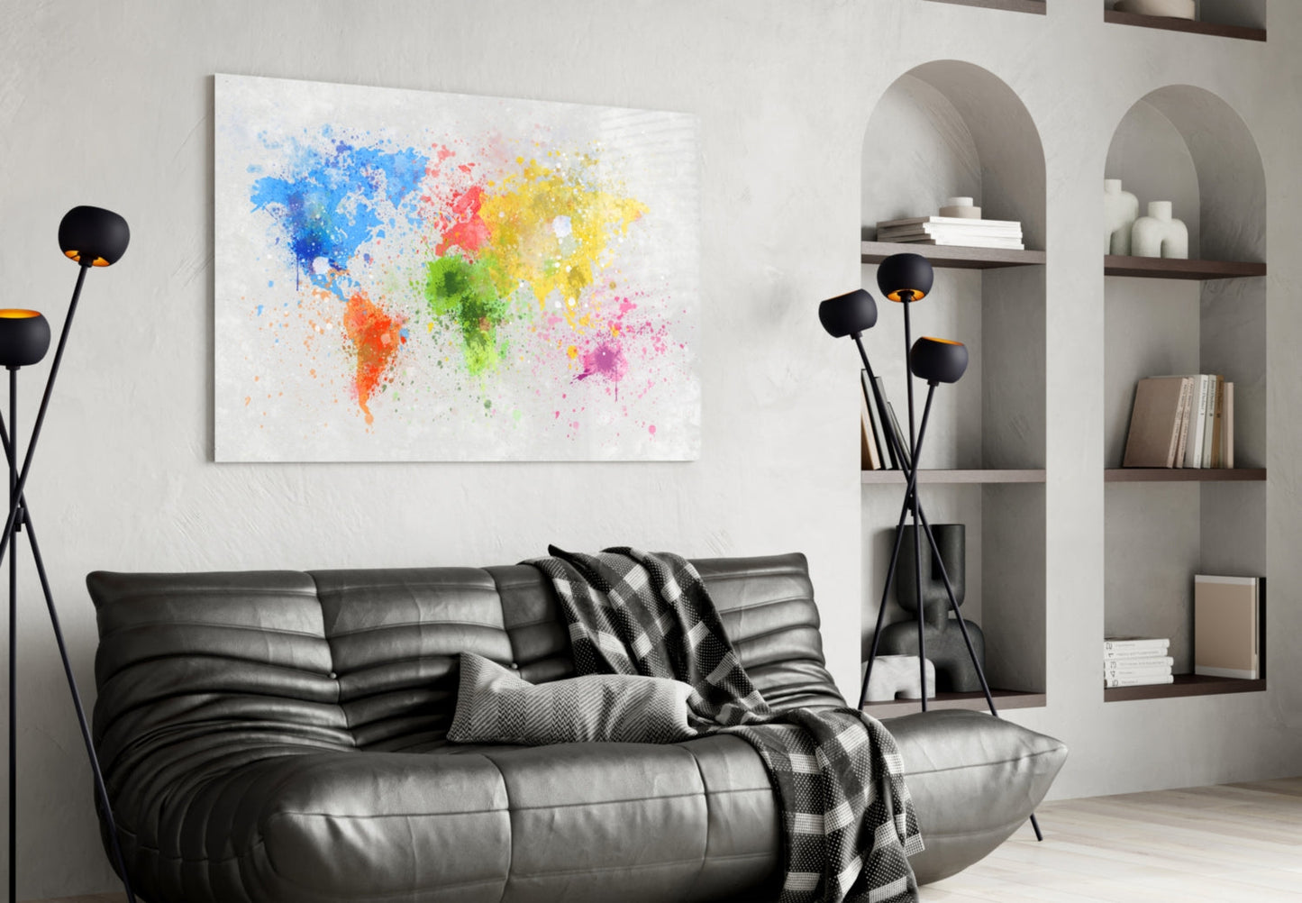 Colorful splatter world map glass art hanging above black leather sofa in modern living room with shelving.