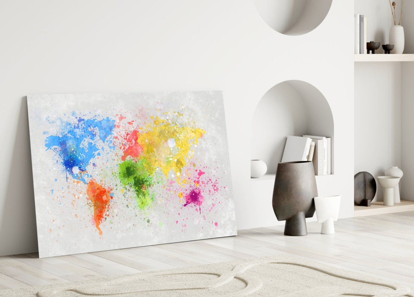 Colorful watercolor world map canvas leaning against white wall in minimalist interior with decorative objects.