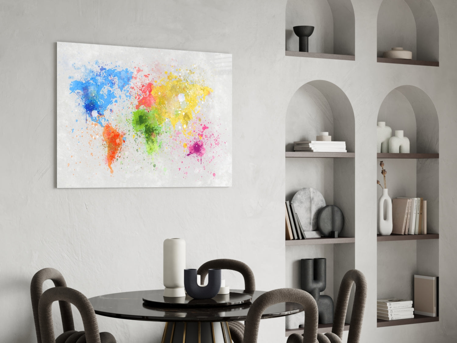 Colorful watercolor world map canvas displayed above black dining table in modern interior with built-in shelving.