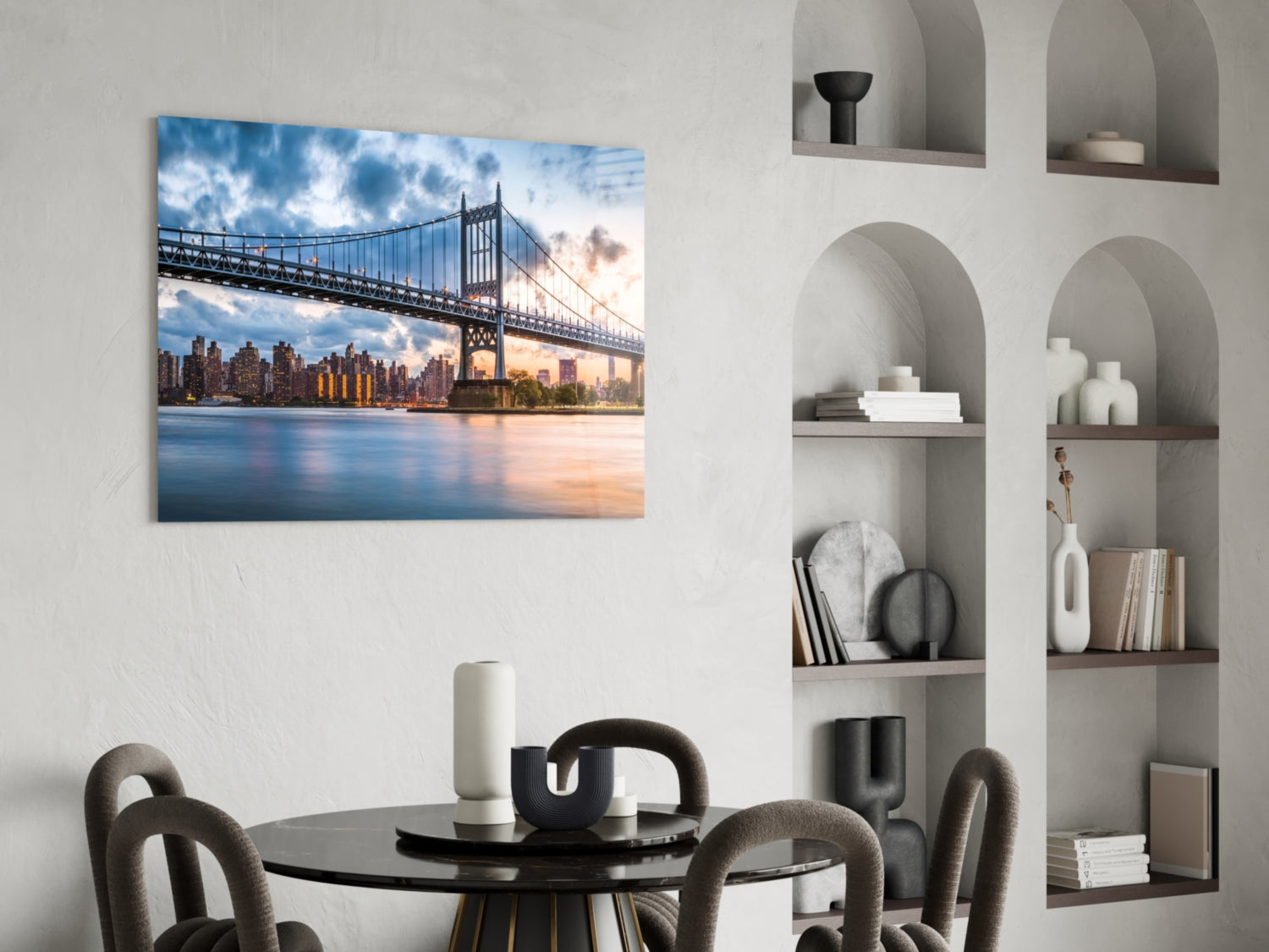 Glass wall art depicting Queensboro Bridge at sunset with Manhattan skyline, displayed above black dining table in modern interior.