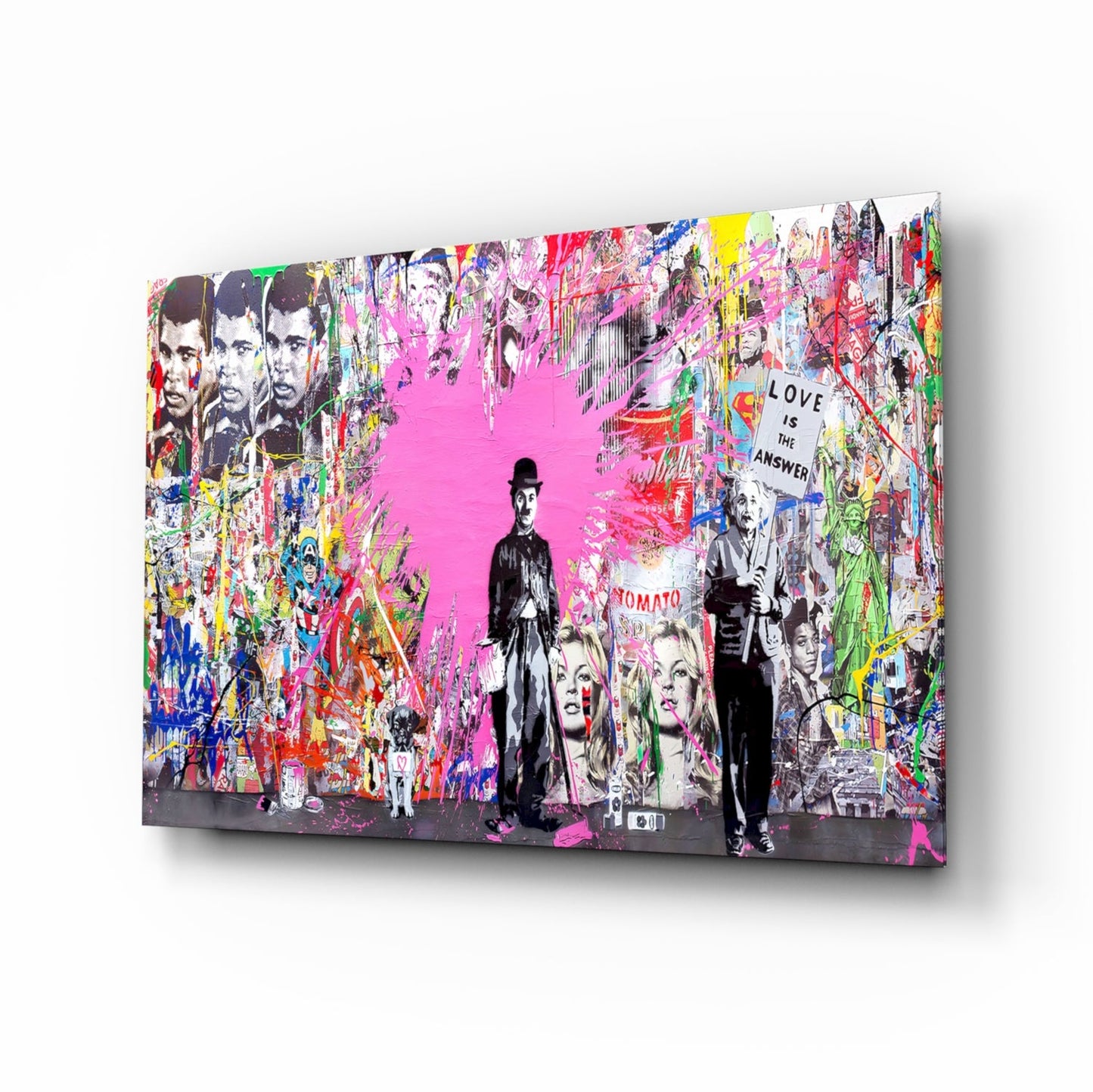 Angled view of colorful glass wall art featuring black and white figures overlaid on vibrant pink and multi-colored graffiti-style background with "Love is the Answer" text.