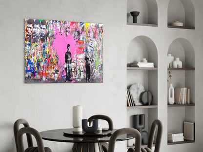 Vibrant pop art glass wall panel with pink background, colorful graffiti, and portrait figures displayed above modern dining table.