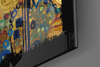 Gold abstract glass wall art displayed at an angle, showing colorful circular patterns in blue, green, yellow, and red with gold leaf detailing.