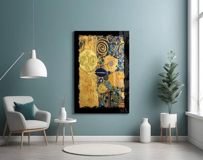 Gold abstract glass wall art with blue spirals and celestial circles displayed above a white armchair in a teal room.