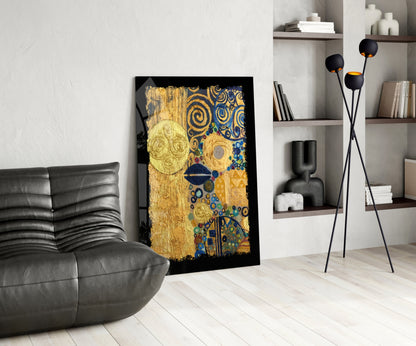 Gold abstract glass wall art with blue and colorful circular patterns displayed in modern living room next to black leather sofa.